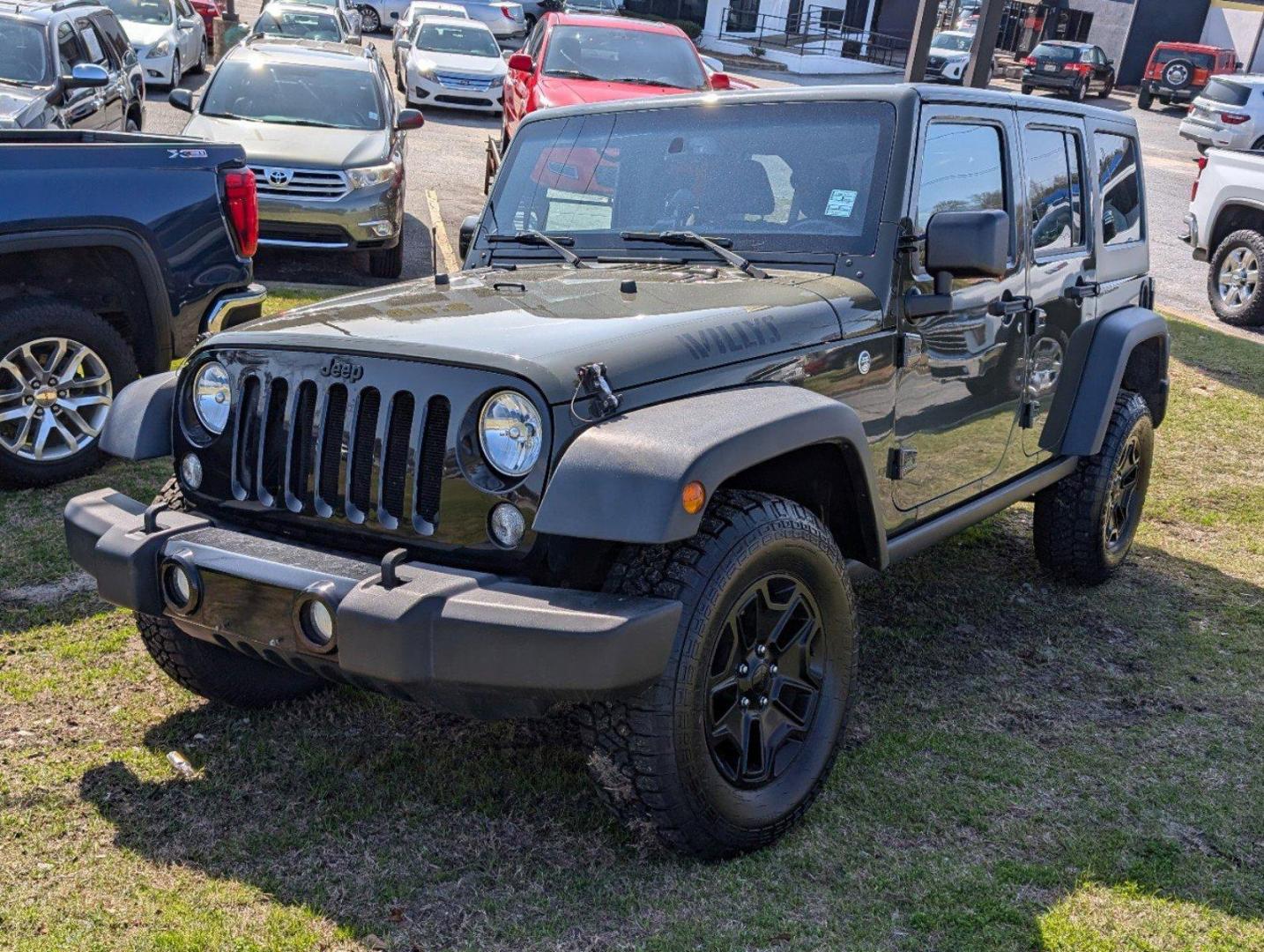 2016 /Black Jeep Wrangler Unlimited Willys Wheeler (1C4BJWDG9GL) with an Regular Unleaded V-6 3.6 L/220 engine, 6-Speed Manual w/OD transmission, located at 804 22nd Ave, Phenix City, AL, 36870, (334) 297-1860, 32.484749, -85.024475 - 2016 Jeep Wrangler Unlimited Willys Wheeler - Photo#0