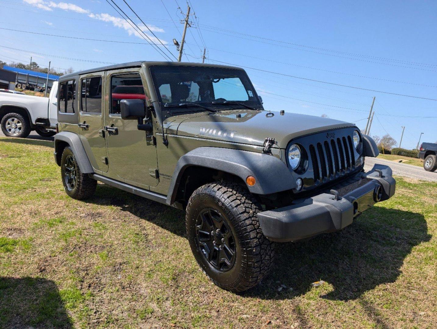 2016 /Black Jeep Wrangler Unlimited Willys Wheeler (1C4BJWDG9GL) with an Regular Unleaded V-6 3.6 L/220 engine, 6-Speed Manual w/OD transmission, located at 804 22nd Ave, Phenix City, AL, 36870, (334) 297-1860, 32.484749, -85.024475 - 2016 Jeep Wrangler Unlimited Willys Wheeler - Photo#2