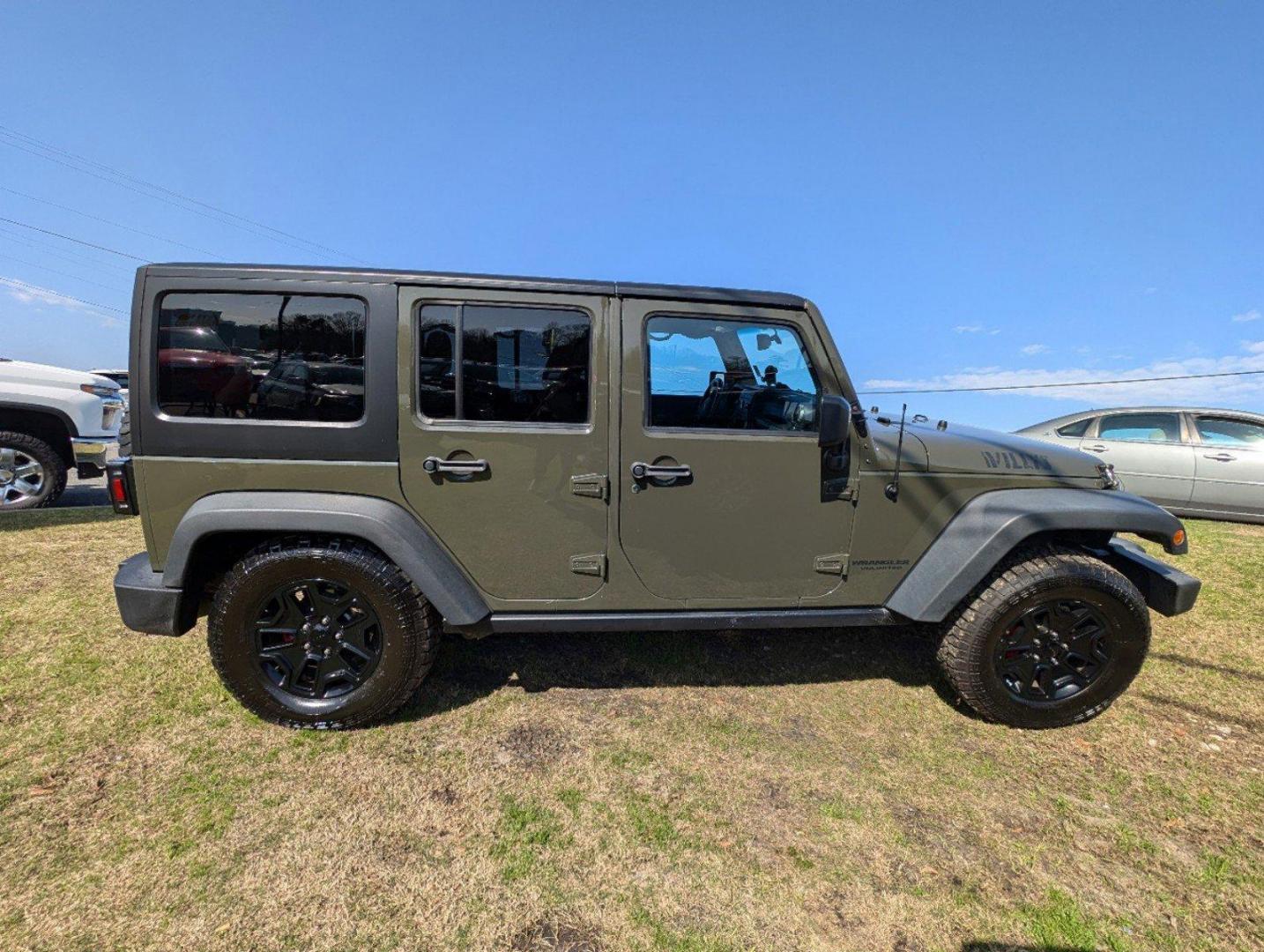 2016 /Black Jeep Wrangler Unlimited Willys Wheeler (1C4BJWDG9GL) with an Regular Unleaded V-6 3.6 L/220 engine, 6-Speed Manual w/OD transmission, located at 804 22nd Ave, Phenix City, AL, 36870, (334) 297-1860, 32.484749, -85.024475 - 2016 Jeep Wrangler Unlimited Willys Wheeler - Photo#3