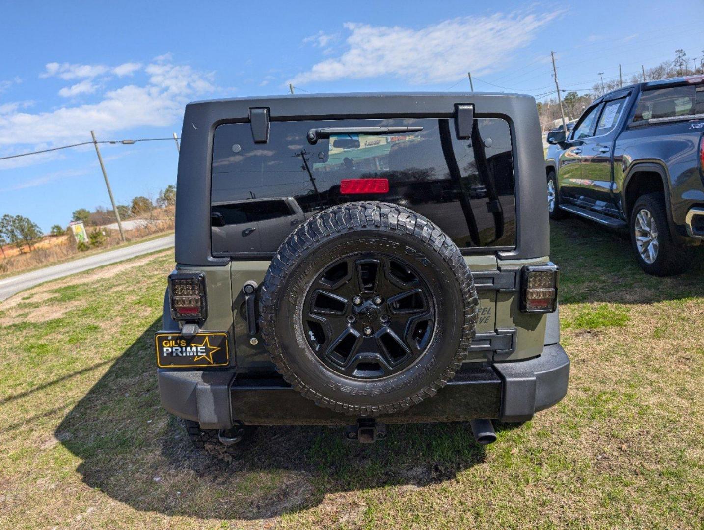 2016 /Black Jeep Wrangler Unlimited Willys Wheeler (1C4BJWDG9GL) with an Regular Unleaded V-6 3.6 L/220 engine, 6-Speed Manual w/OD transmission, located at 804 22nd Ave, Phenix City, AL, 36870, (334) 297-1860, 32.484749, -85.024475 - 2016 Jeep Wrangler Unlimited Willys Wheeler - Photo#5