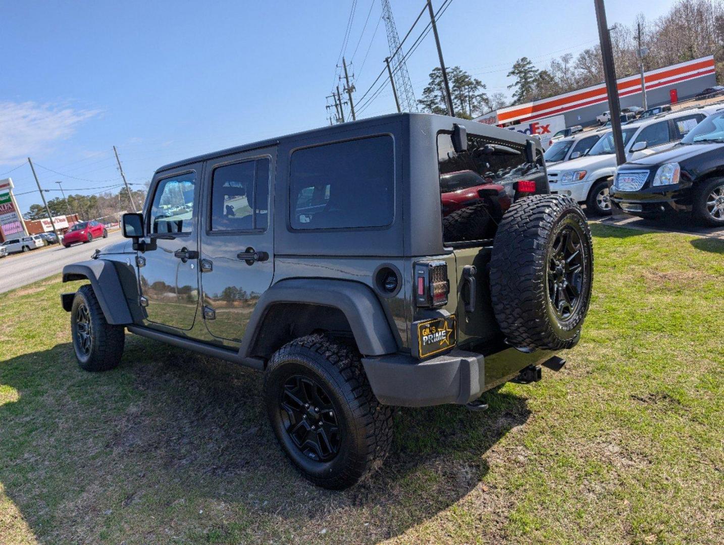 2016 /Black Jeep Wrangler Unlimited Willys Wheeler (1C4BJWDG9GL) with an Regular Unleaded V-6 3.6 L/220 engine, 6-Speed Manual w/OD transmission, located at 804 22nd Ave, Phenix City, AL, 36870, (334) 297-1860, 32.484749, -85.024475 - 2016 Jeep Wrangler Unlimited Willys Wheeler - Photo#6